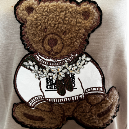 embroidered teddy bear. detail of the pullover
